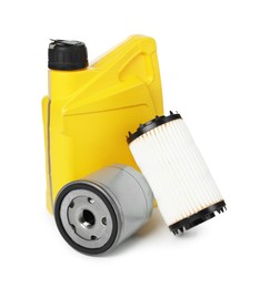 Photo of Motor oil in yellow canister and filters isolated on white