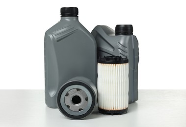 Photo of Motor oil in plastic canisters and filters isolated on white