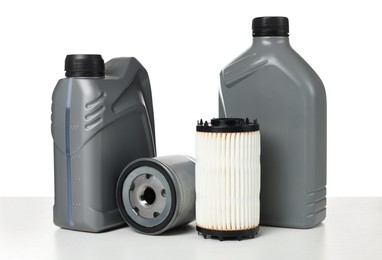 Photo of Motor oil in plastic canisters and filters isolated on white