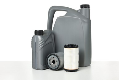 Photo of Motor oil in plastic canisters and filters isolated on white
