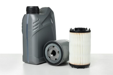Photo of Motor oil in plastic canisters and filters isolated on white