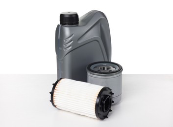 Photo of Motor oil in plastic canister and filters isolated on white