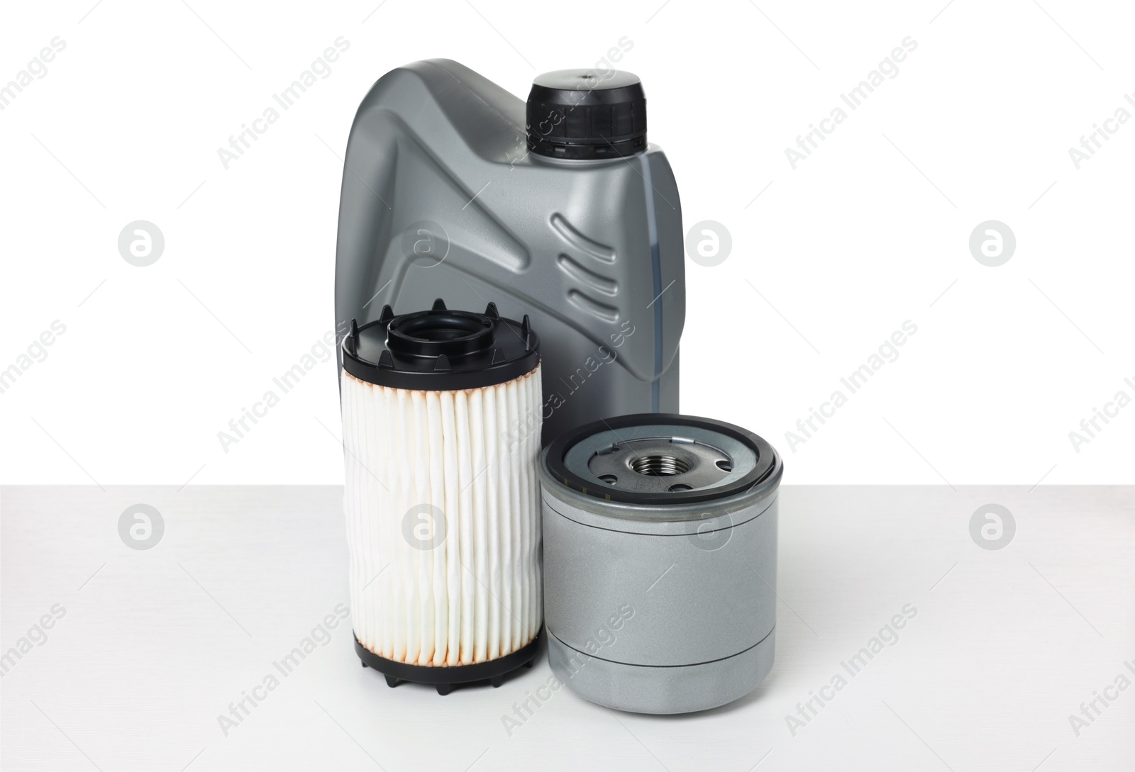 Photo of Motor oil in plastic canister and filters isolated on white