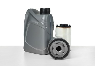 Photo of Motor oil in plastic canister and filters isolated on white