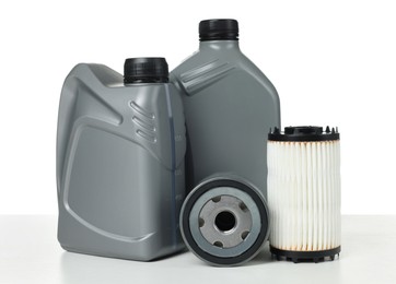 Photo of Motor oil in plastic canisters and filters isolated on white