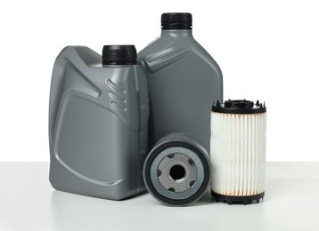 Photo of Motor oil in plastic canisters and filters isolated on white