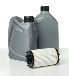 Photo of Motor oil in plastic canisters and filter isolated on white