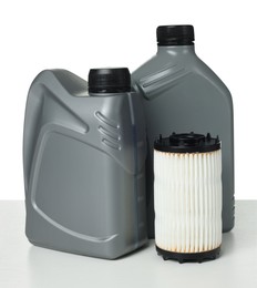 Photo of Motor oil in plastic canisters and filter isolated on white