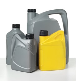 Photo of Motor oil in plastic canisters isolated on white