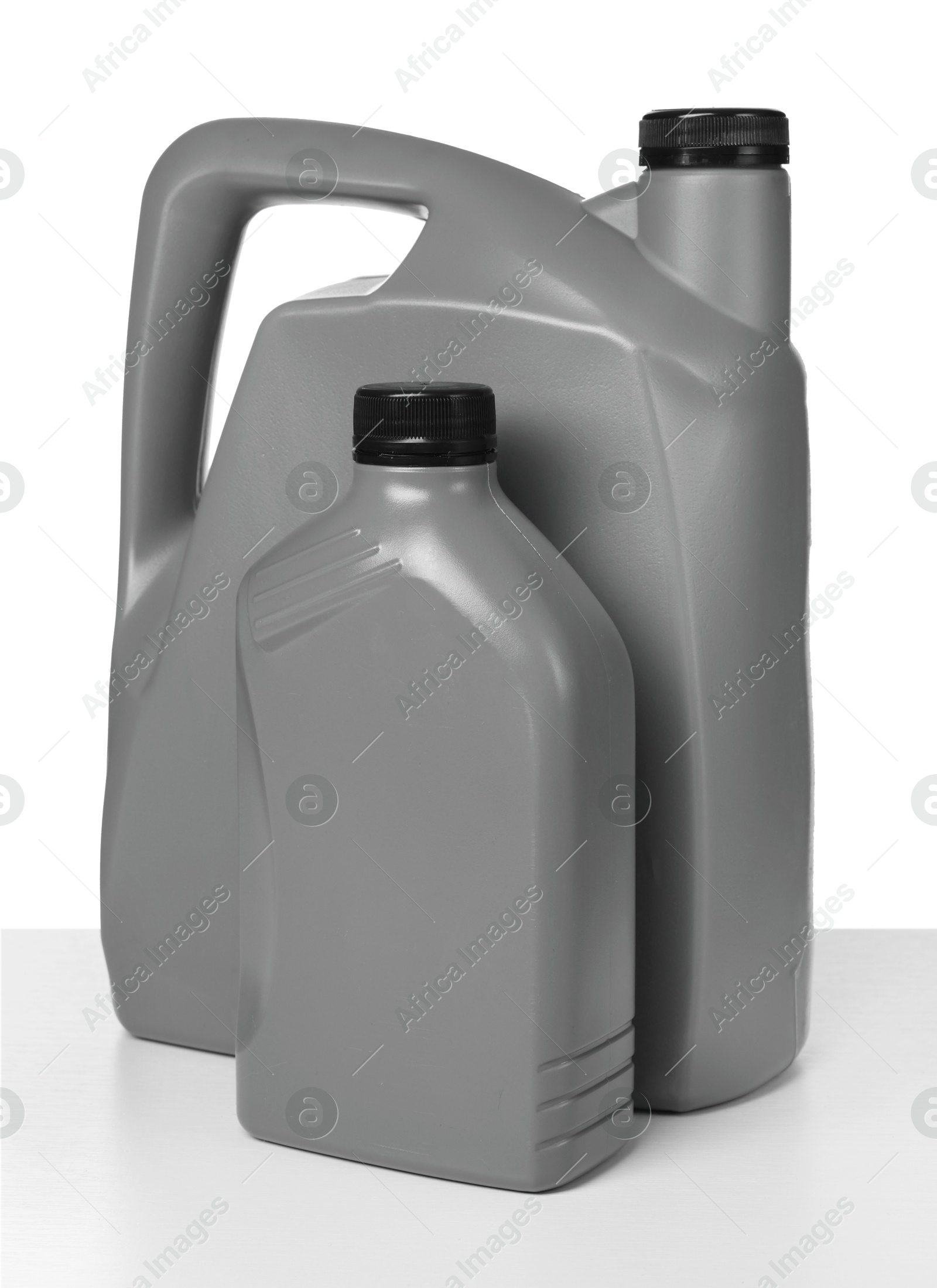 Photo of Motor oil in plastic canisters isolated on white