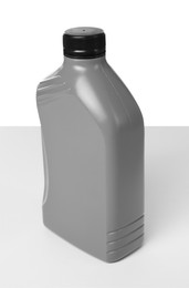 Photo of Motor oil in plastic canister isolated on white