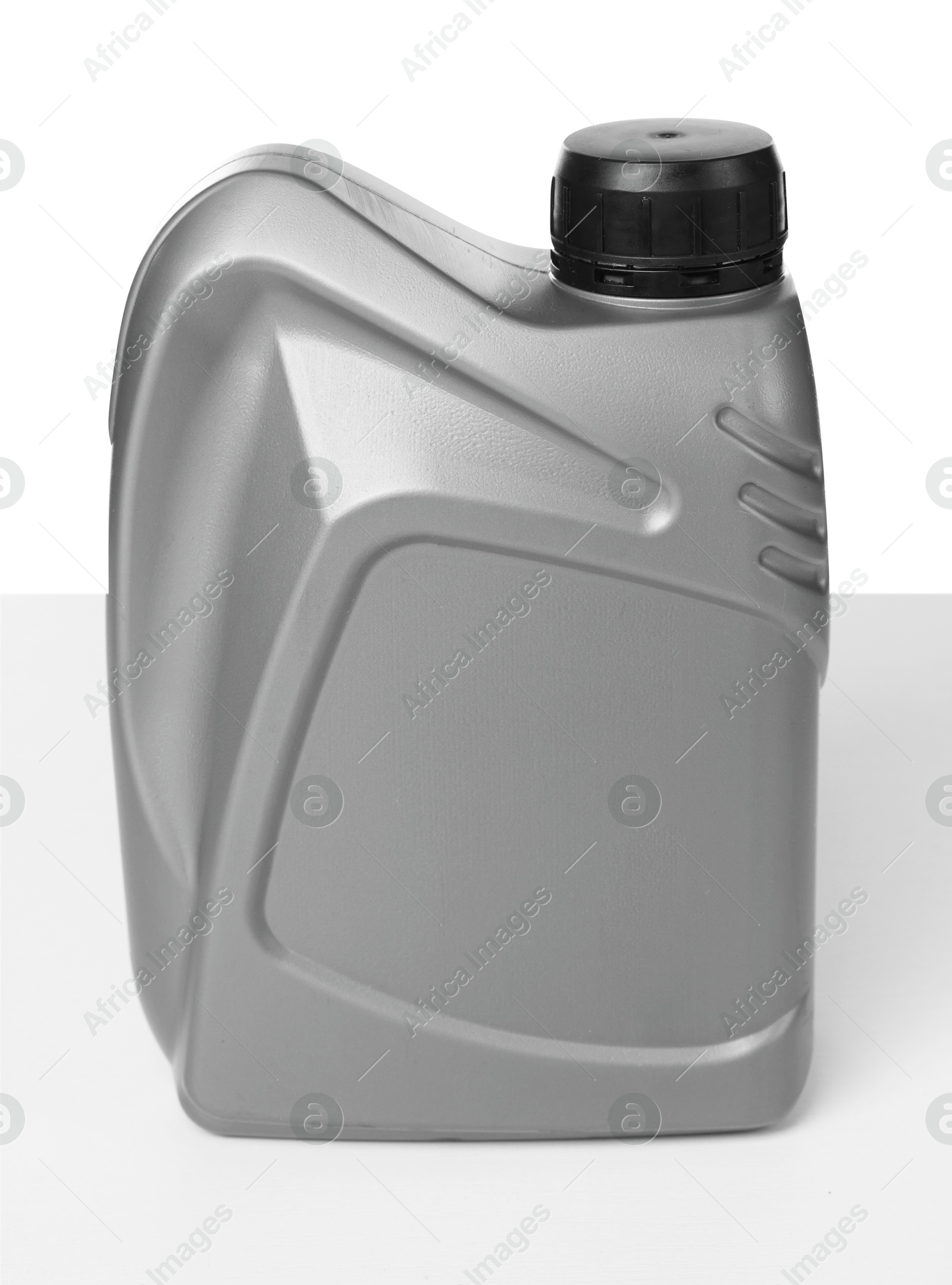 Motor oil in plastic canister isolated on white Photo of Motor oil in plastic canister isolated on white