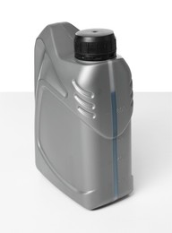 Photo of Motor oil in plastic canister isolated on white