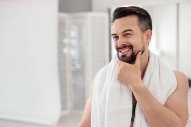 Photo of Smiling man before shaving in bathroom. Space for text