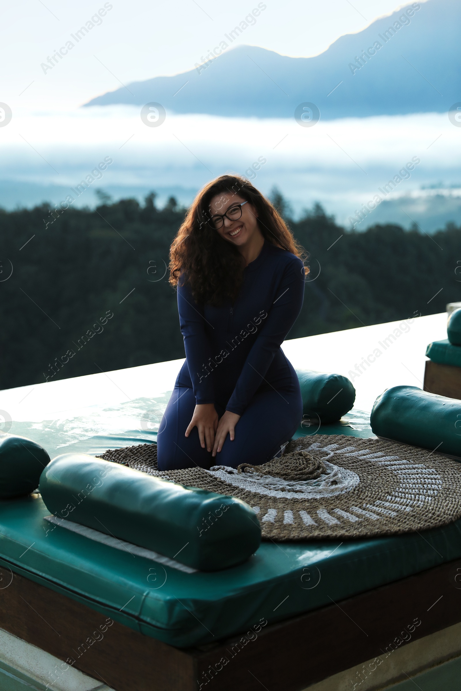 Beautiful woman enjoying picturesque view of mountains Photo of Beautiful woman enjoying picturesque view of mountains