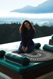 Photo of Beautiful woman enjoying picturesque view of mountains