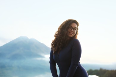 Photo of Beautiful woman enjoying picturesque view of mountains
