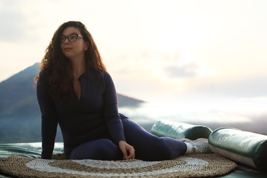 Photo of Beautiful woman enjoying picturesque view of mountains. Space for text