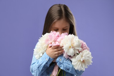 Photo of Cute little girl with bouquet of beautiful peonies on purple background