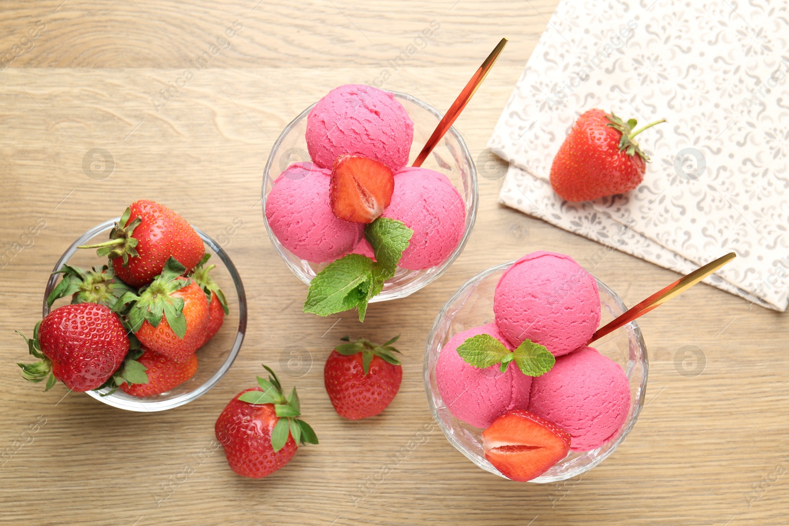 Photo of Refreshing sorbet, strawberries and mint on wooden table, flat lay