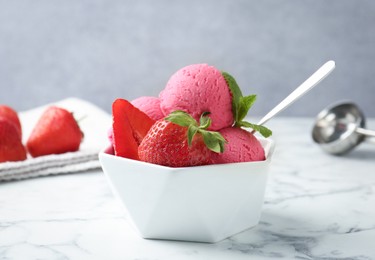 Photo of Refreshing sorbet, strawberries and mint in bowl on white marble table against grey background, closeup