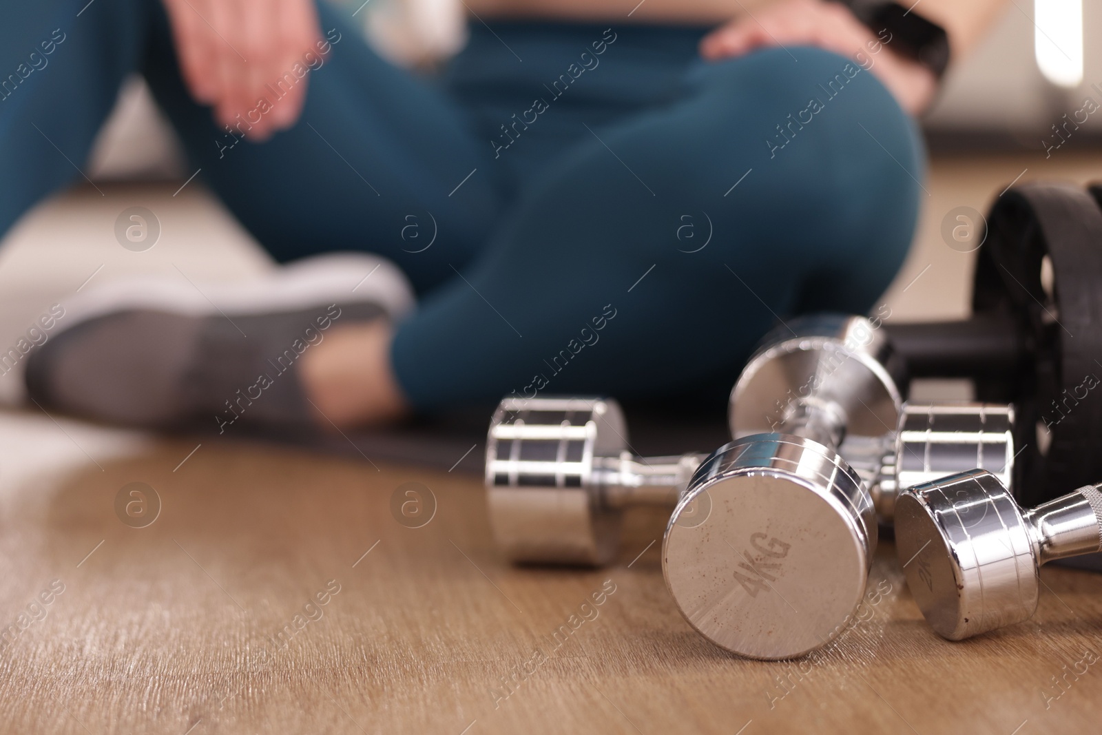 Woman with different sports equipment in fitness studio, closeup Photo of Woman with different sports equipment in fitness studio, closeup