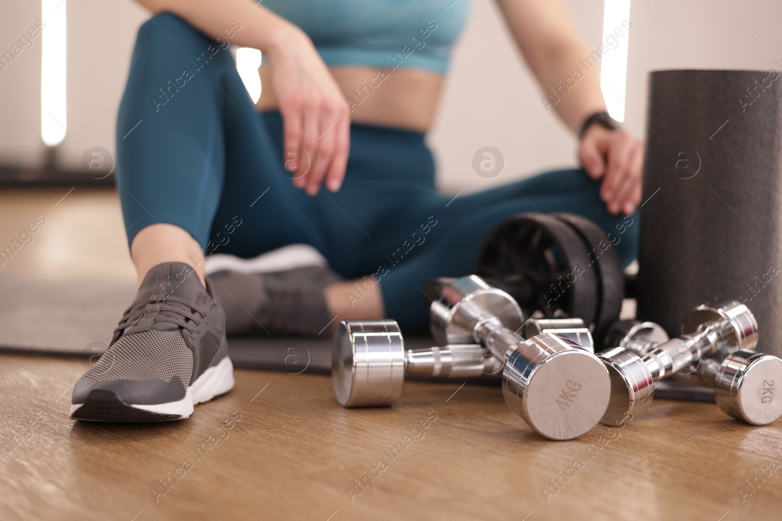 Woman with different sports equipment in fitness studio, closeup Photo of Woman with different sports equipment in fitness studio, closeup