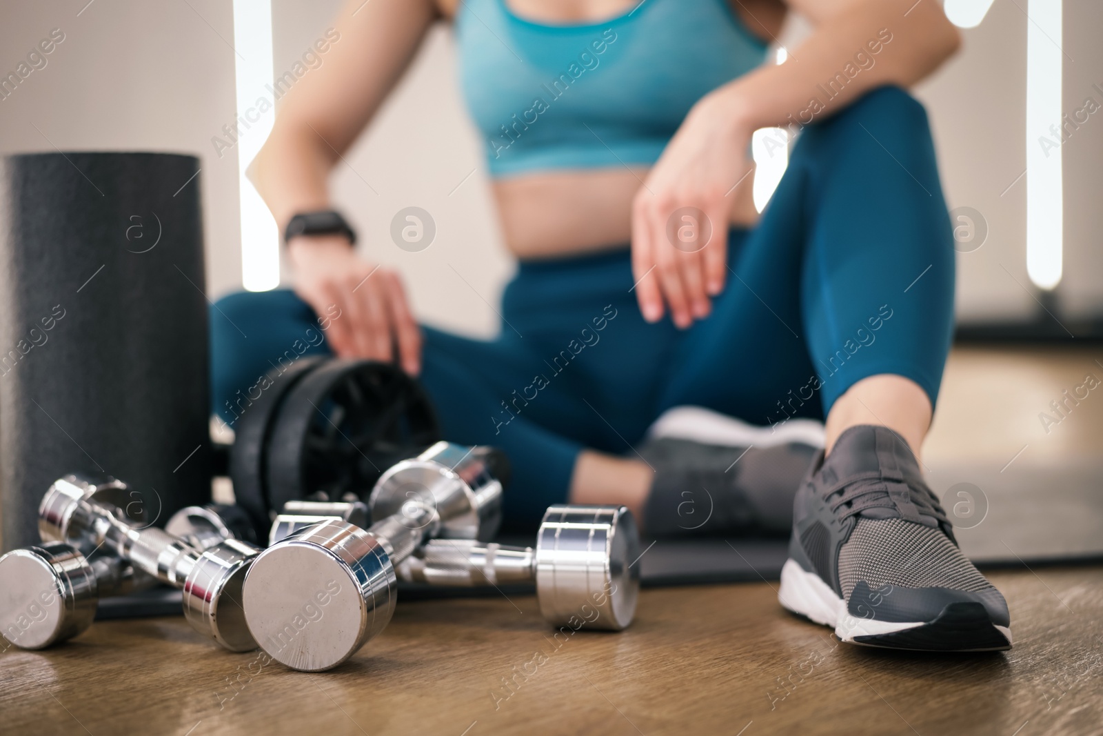 Woman with different sports equipment in fitness studio, closeup Photo of Woman with different sports equipment in fitness studio, closeup