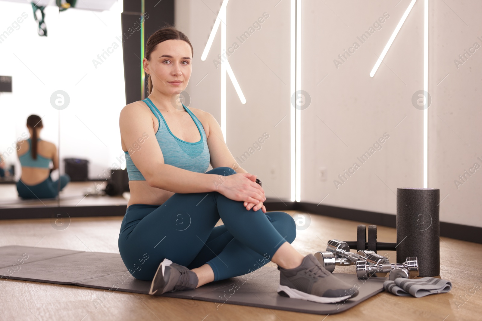 Photo of Woman with different sports equipment in fitness studio
