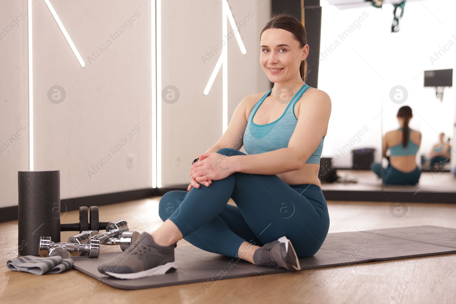 Photo of Woman with different sports equipment in fitness studio