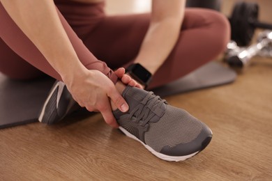 Photo of Sportswoman with leg injury in fitness studio, closeup
