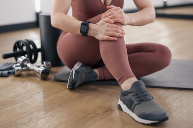 Photo of Sportswoman with leg injury in fitness studio, closeup