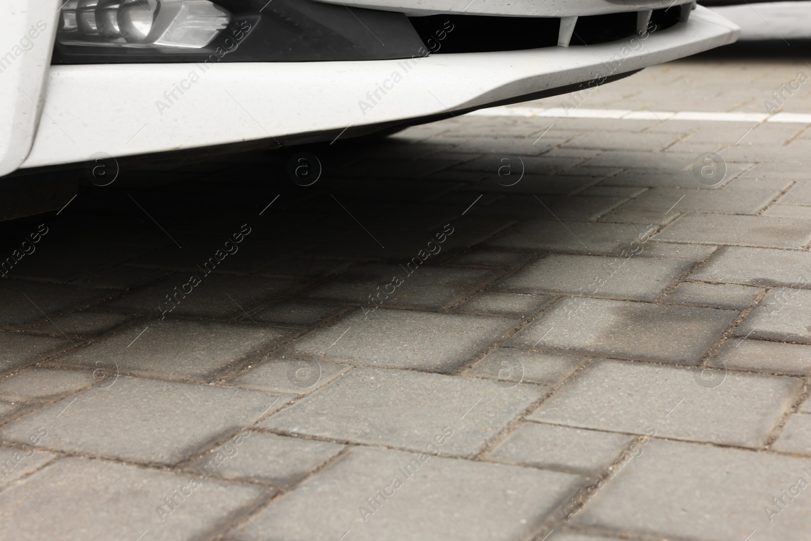 Stains of motor oil on road under car outdoors, closeup Photo of Stains of motor oil on road under car outdoors, closeup