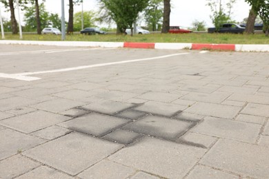 Photo of Stains of motor oil on road outdoors, closeup