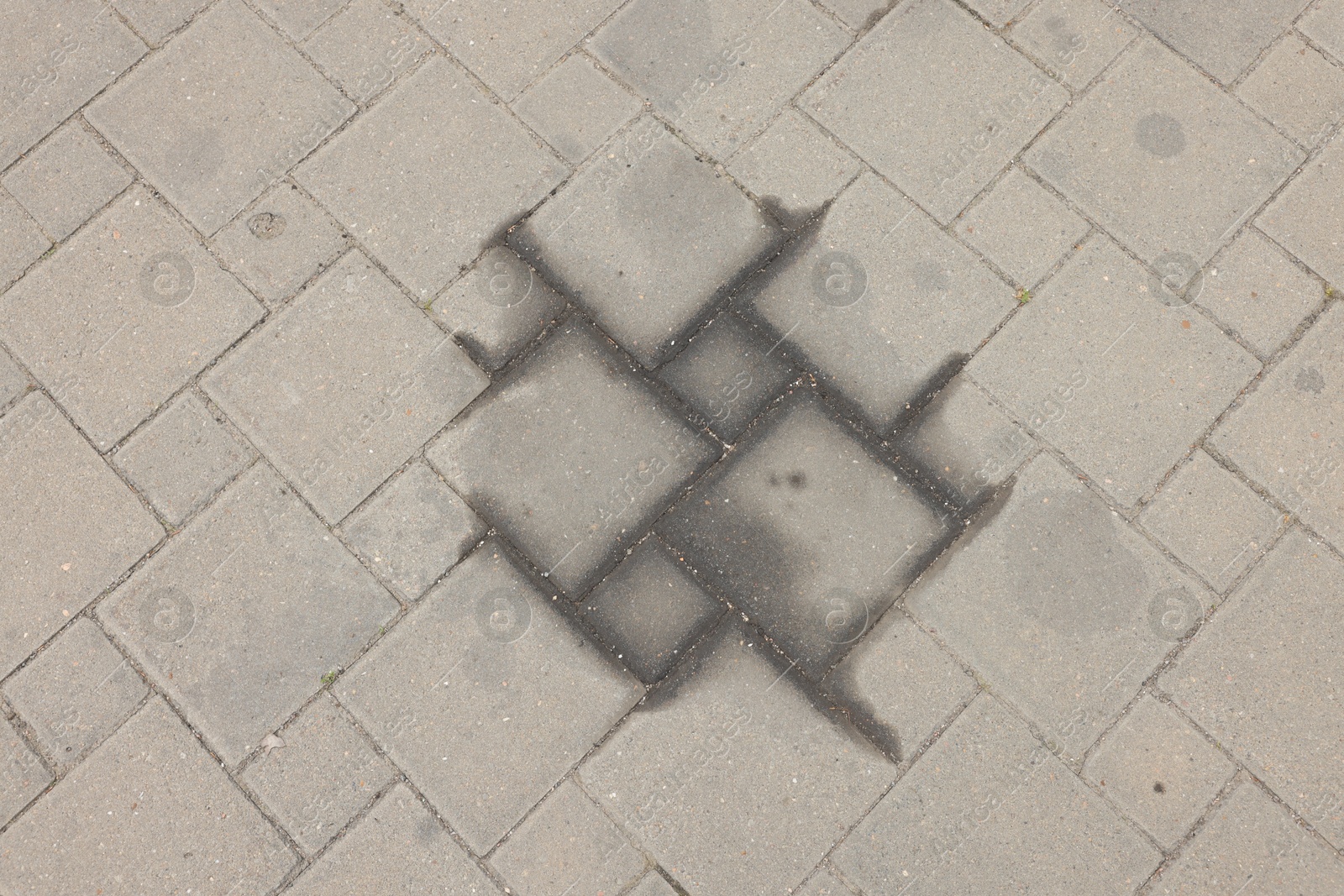 Stains of motor oil on road outdoors, top view Photo of Stains of motor oil on road outdoors, top view