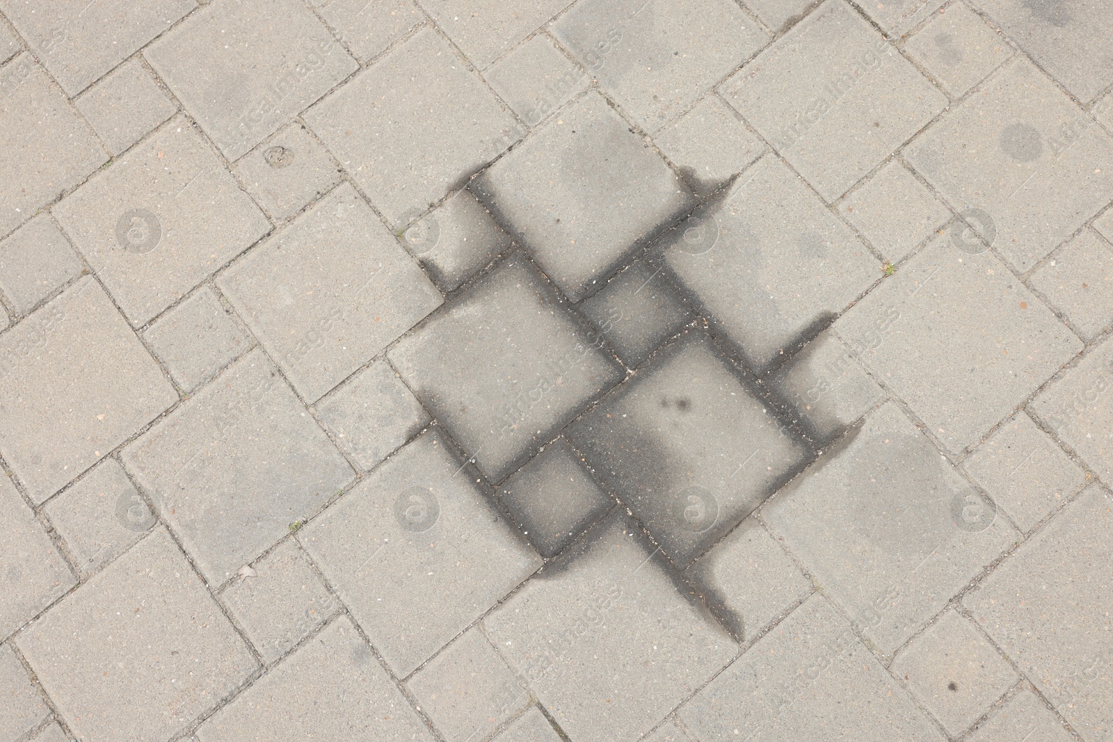 Stains of motor oil on road outdoors, top view Photo of Stains of motor oil on road outdoors, top view