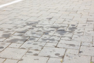 Photo of Stains of motor oil on road outdoors, closeup