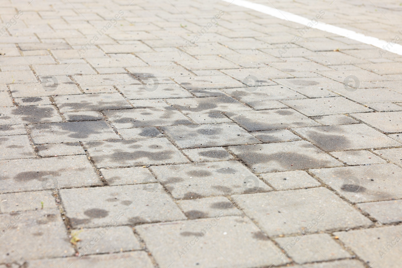 Stains of motor oil on road outdoors, closeup Photo of Stains of motor oil on road outdoors, closeup