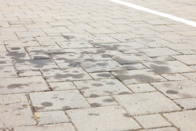 Photo of Stains of motor oil on road outdoors, closeup