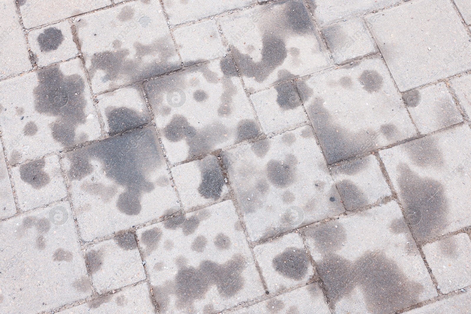 Stains of motor oil on road outdoors, top view Photo of Stains of motor oil on road outdoors, top view