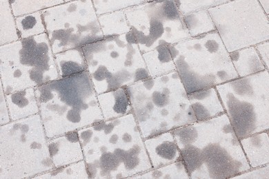 Photo of Stains of motor oil on road outdoors, top view