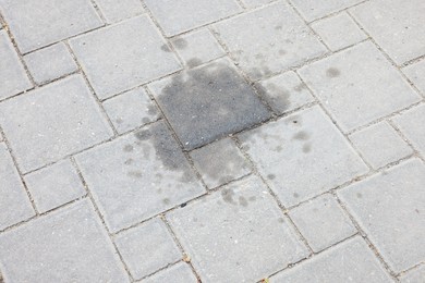 Photo of Stains of motor oil on road outdoors, closeup