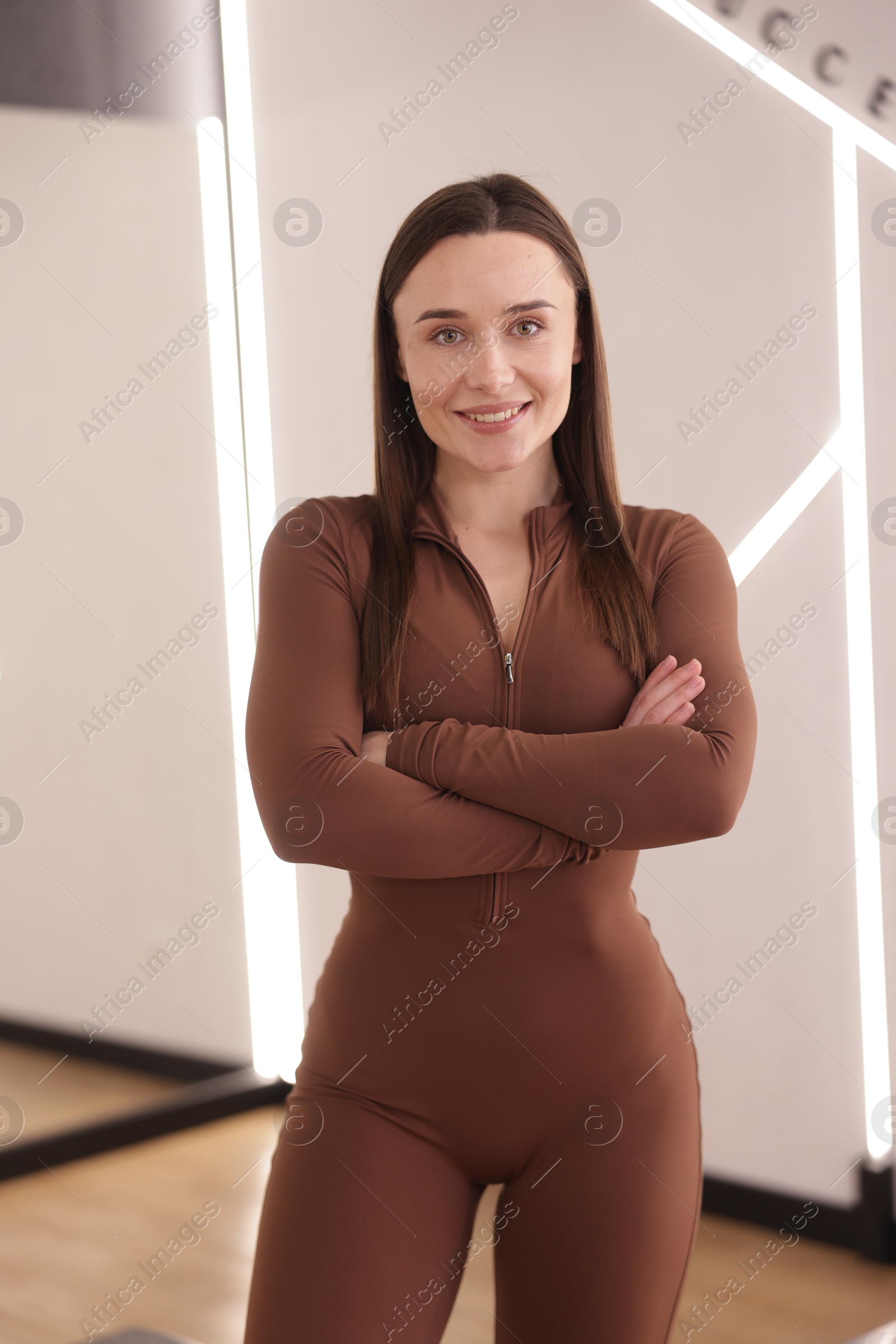 Photo of Happy woman wearing sportswear in fitness studio
