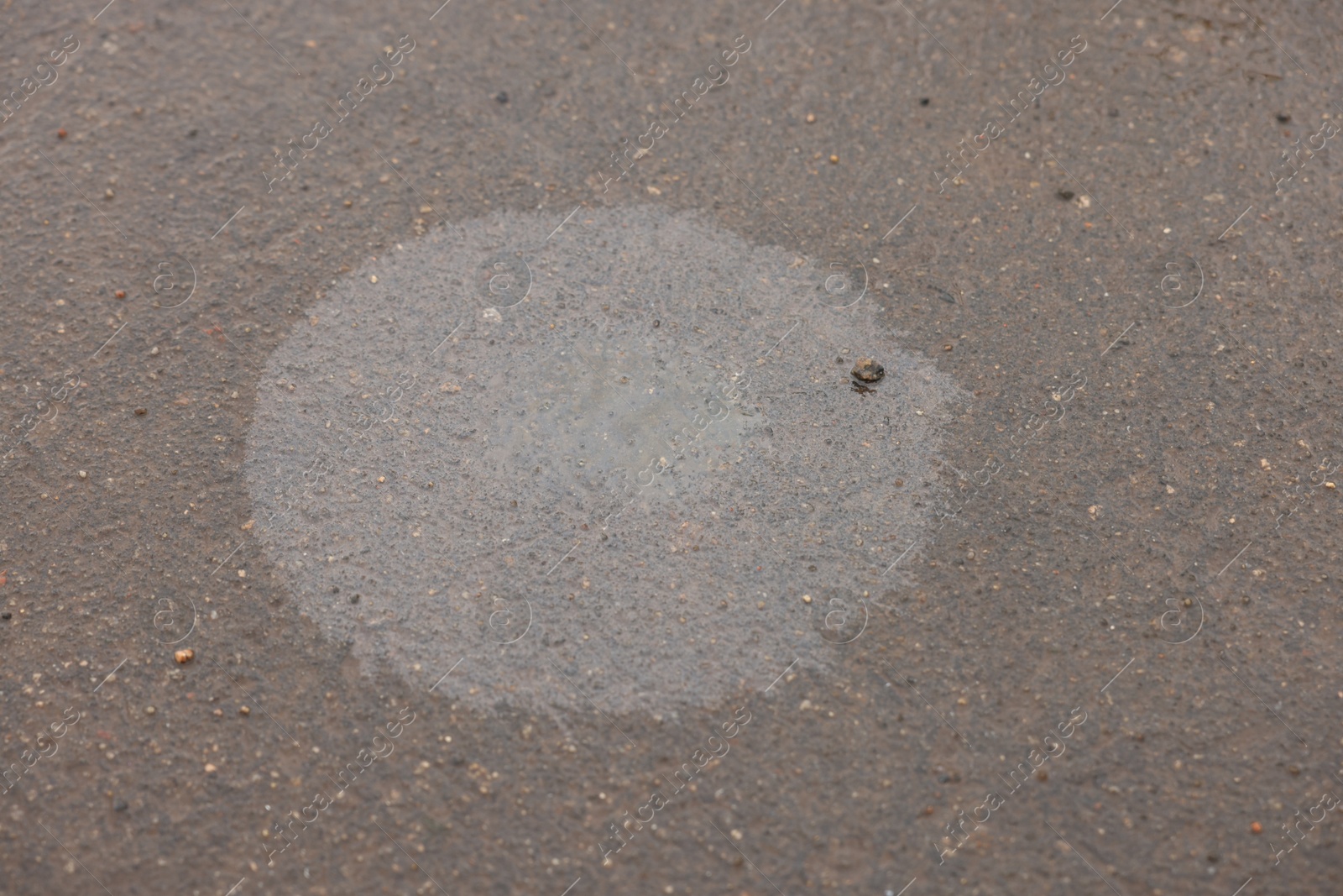 Stain of motor oil on asphalt, above view Photo of Stain of motor oil on asphalt, above view