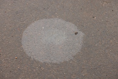 Photo of Stain of motor oil on asphalt, above view