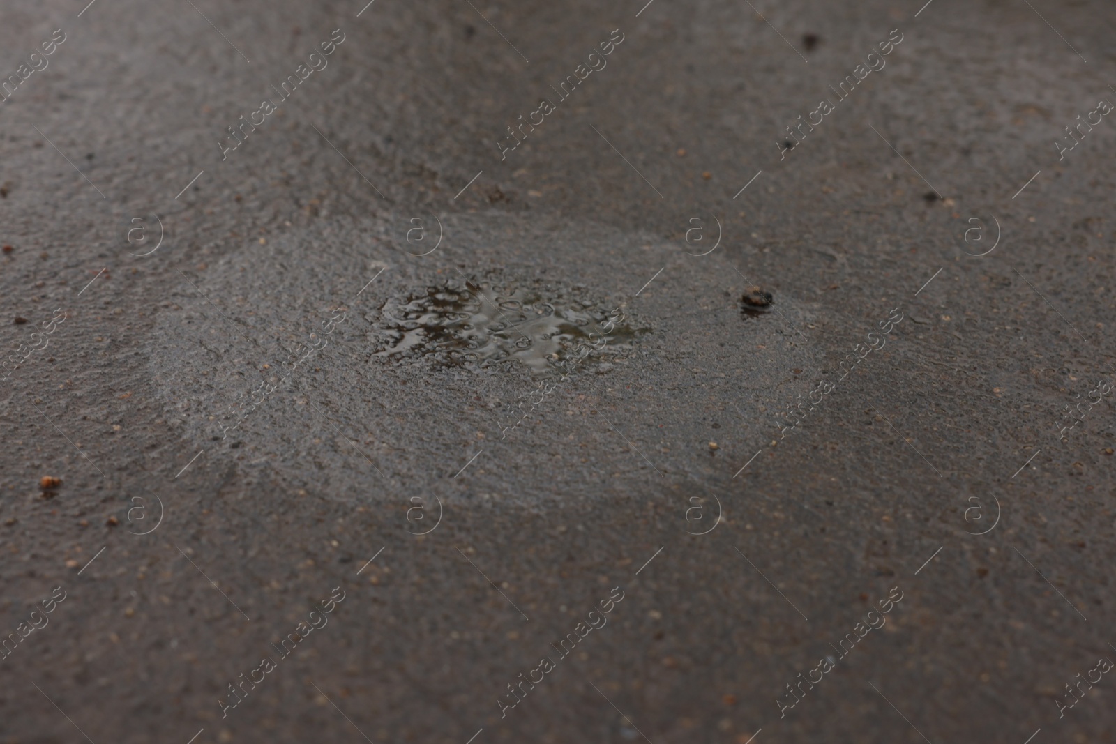 Stain of motor oil on asphalt, closeup view Photo of Stain of motor oil on asphalt, closeup view