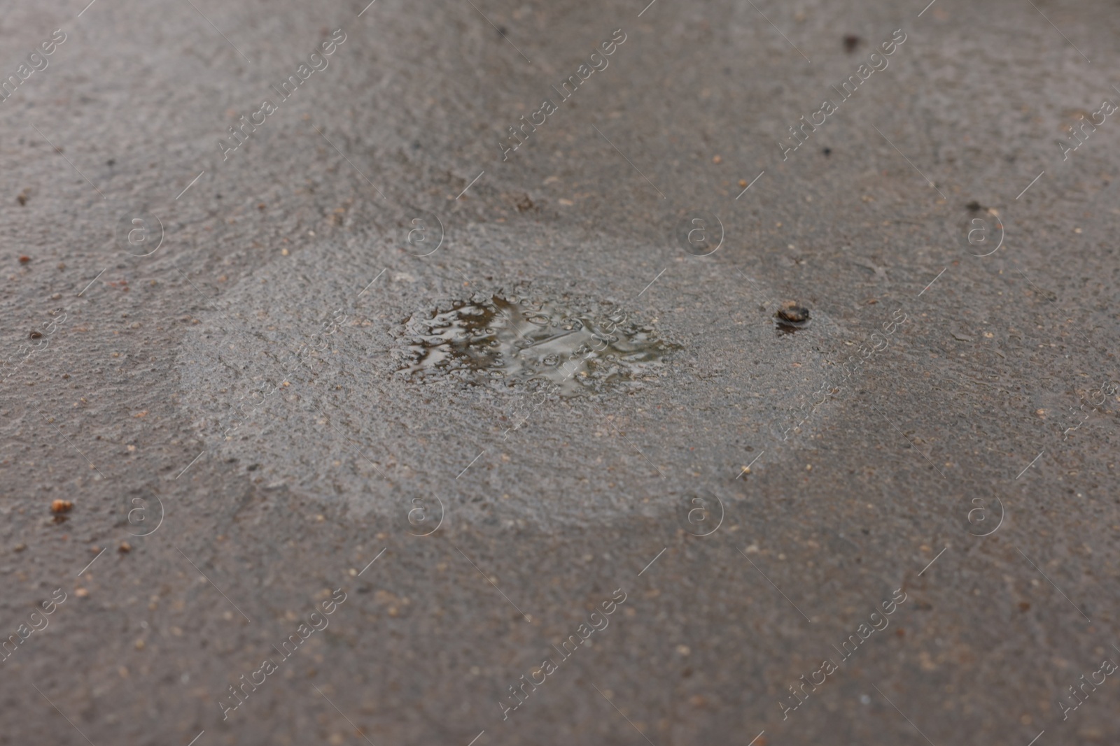 Stain of motor oil on asphalt, closeup view Photo of Stain of motor oil on asphalt, closeup view