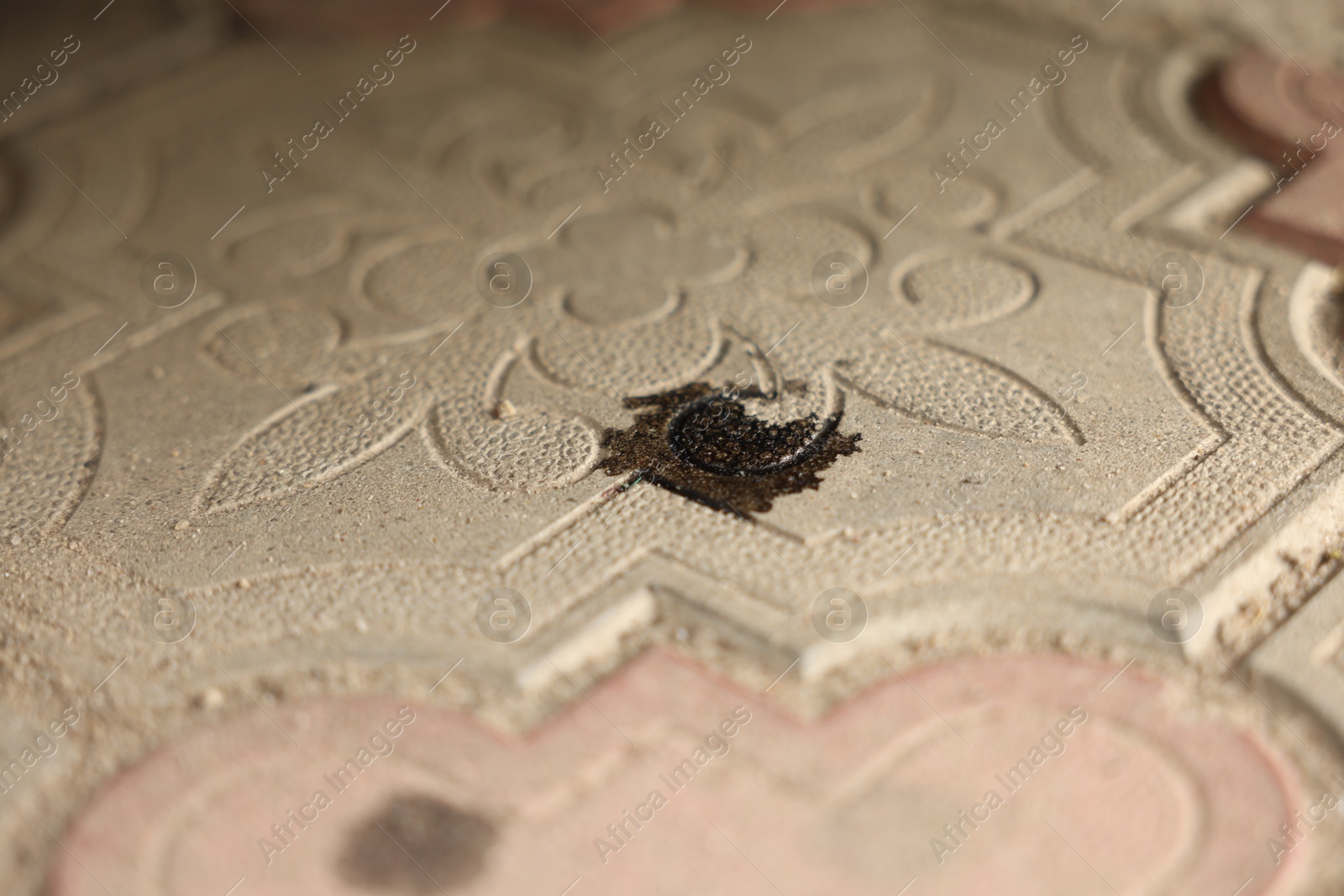 Photo of Stain of motor oil on road outdoors, closeup