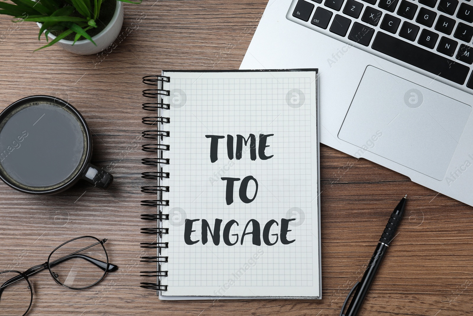 Time To Engage phrase written in notebook on office desk, top view Image of Time To Engage phrase written in notebook on office desk, top view