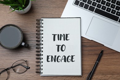 Image of Time To Engage phrase written in notebook on office desk, top view